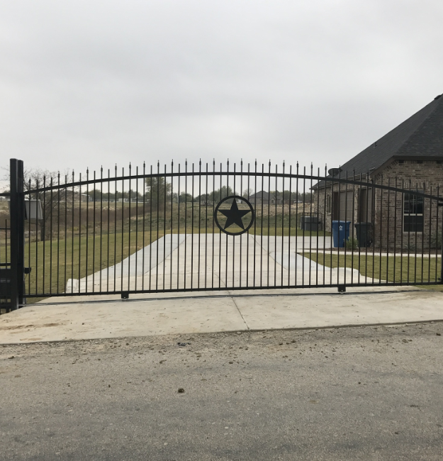 large black metal sliding gate in Texas with a star