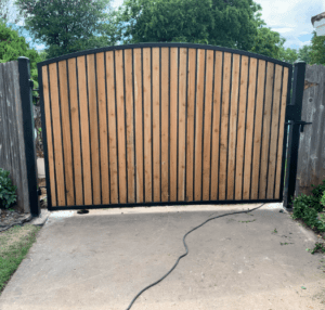 metal and wooden driveway gate in dallas Texas having Automatic Gate Maintenance